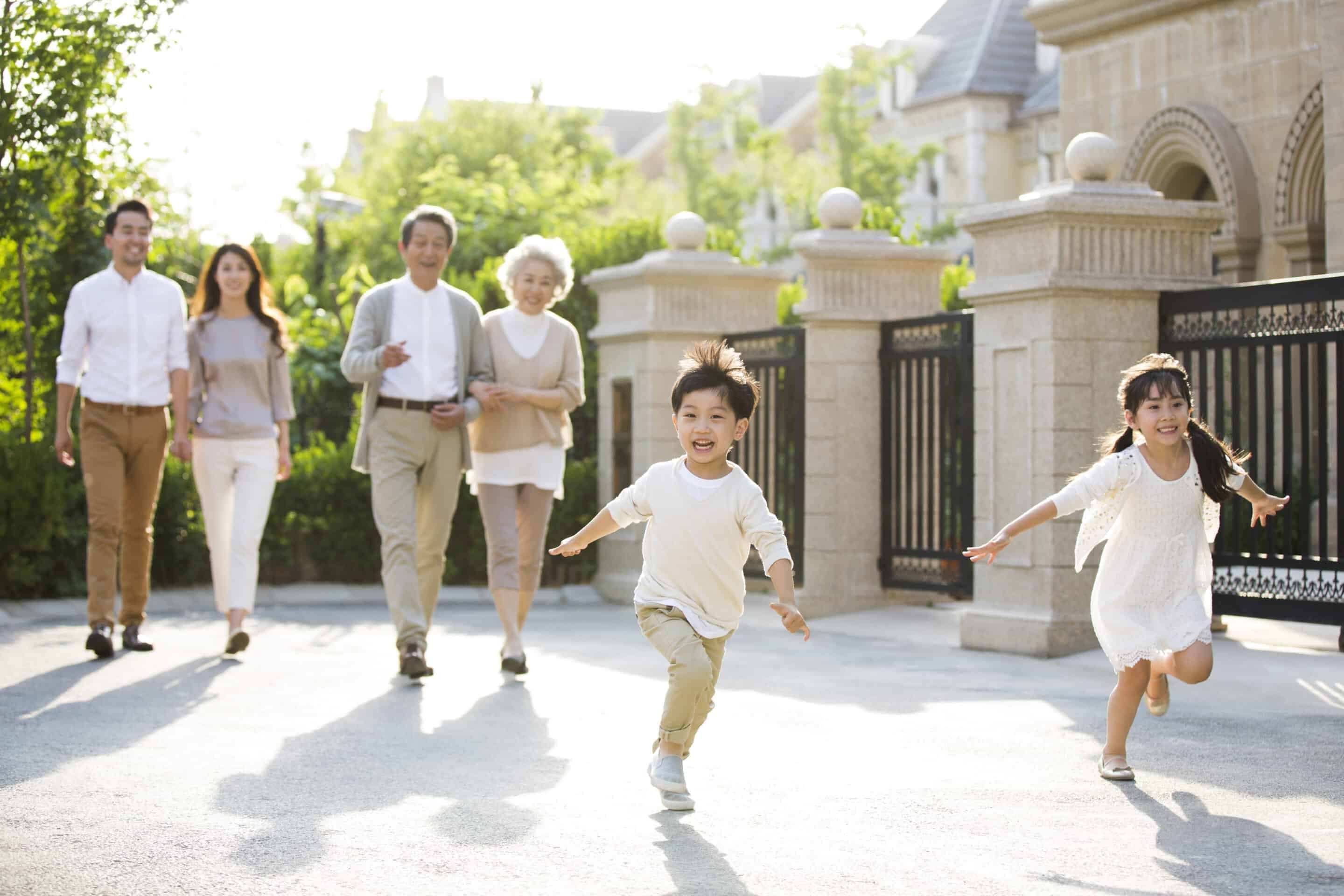 Happy Chinese family strolling outside