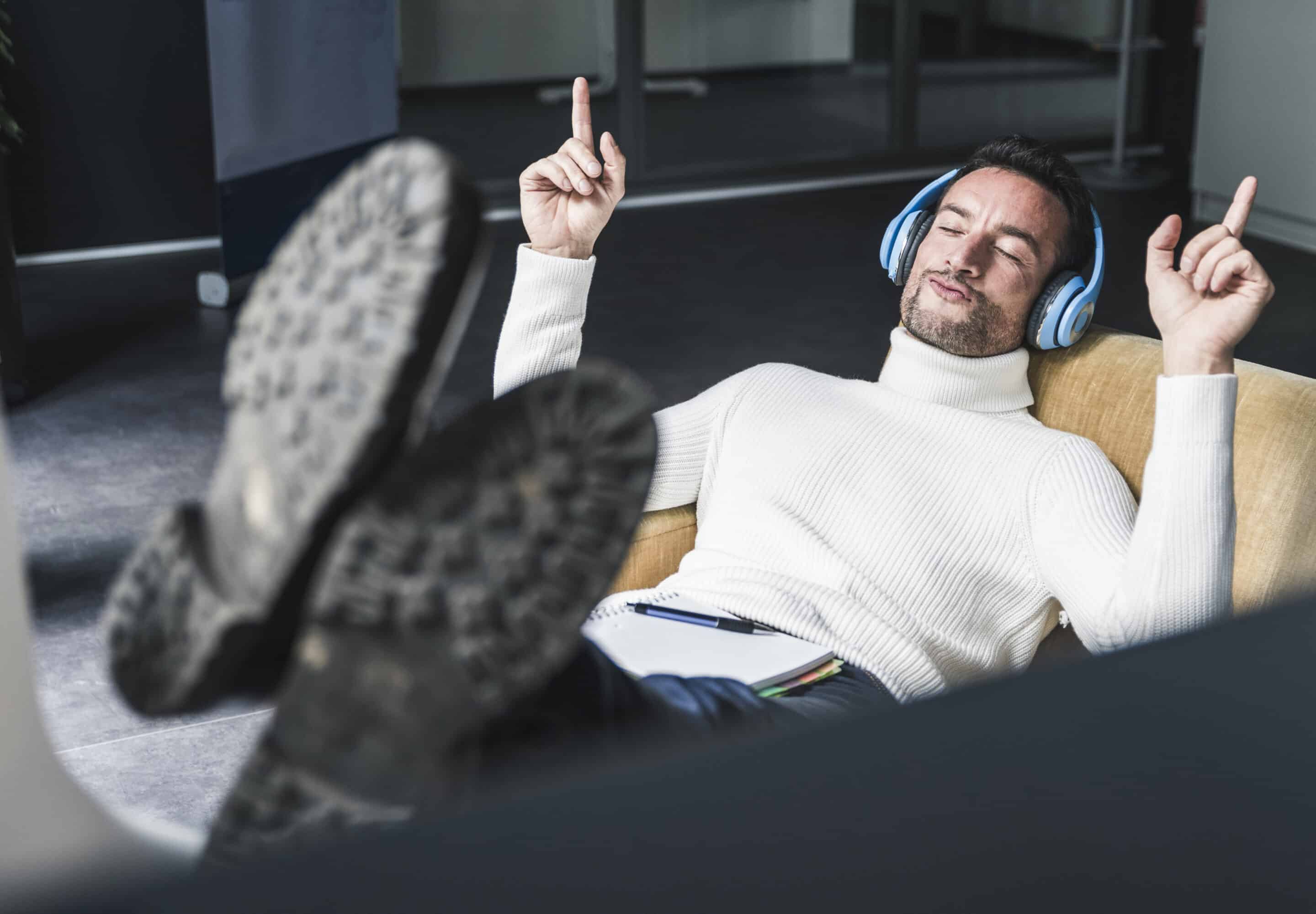 Businessman listening relaxed music in his office